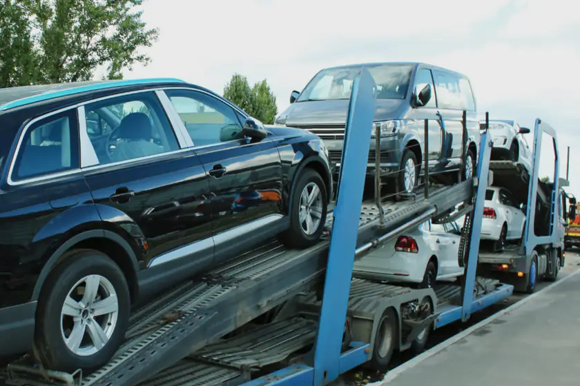 A car transporter loaded with cars on an open road